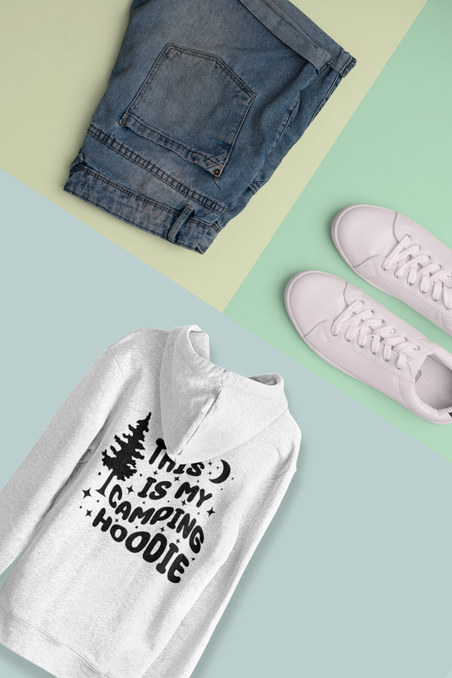 Casual camping outfit display featuring stylish hoodie, jean shorts, and sneakers laid out on a soft mint colours background, perfect for outdoor adventures