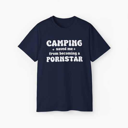 Dark blue t-shirt with the bold statement 'Camping saved me from becoming a pornstar,' embellished with stars on a plain background.