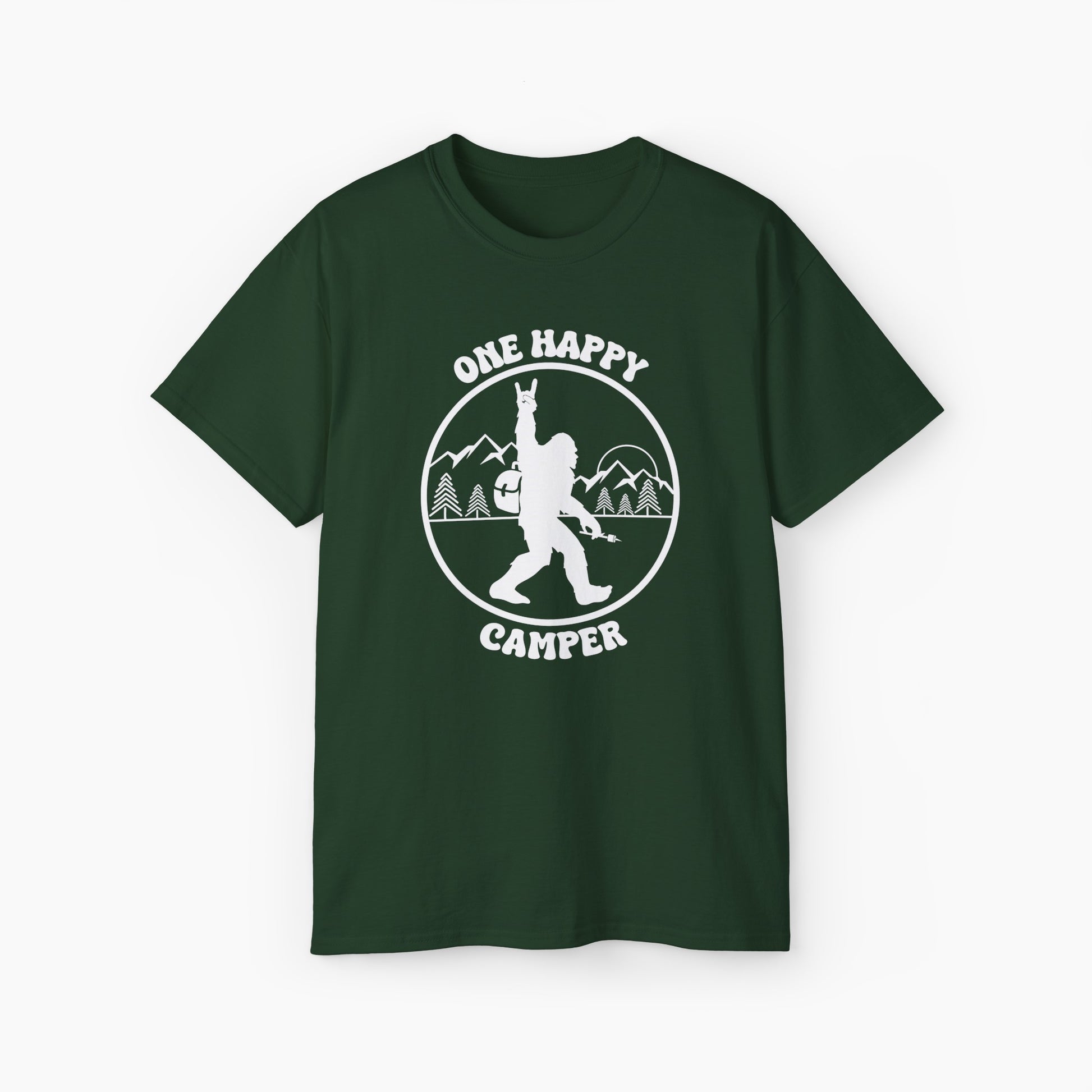 Green t-shirt with 'One Happy Camper' text, featuring Bigfoot making a peace sign, set against a subtle background of trees and mountains.