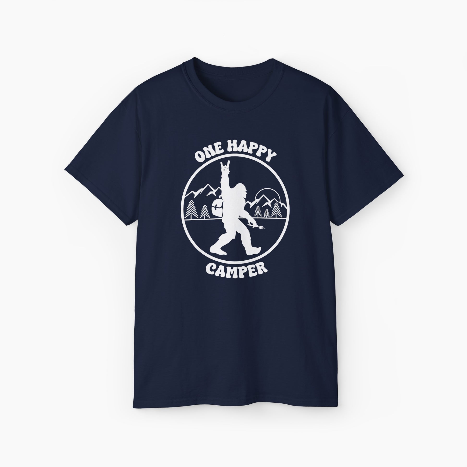 Dark blue t-shirt with 'One Happy Camper' text, featuring Bigfoot making a peace sign, set against a subtle background of trees and mountains.