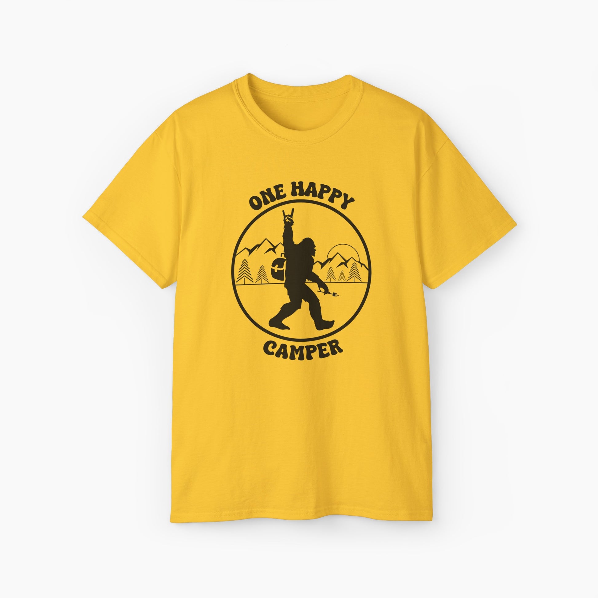 Yellow t-shirt with 'One Happy Camper' text, featuring Bigfoot making a peace sign, set against a subtle background of trees and mountains.
