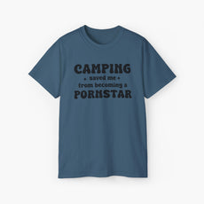 Dark blue t-shirt with the bold statement 'Camping saved me from becoming a pornstar,' embellished with stars on a plain background.