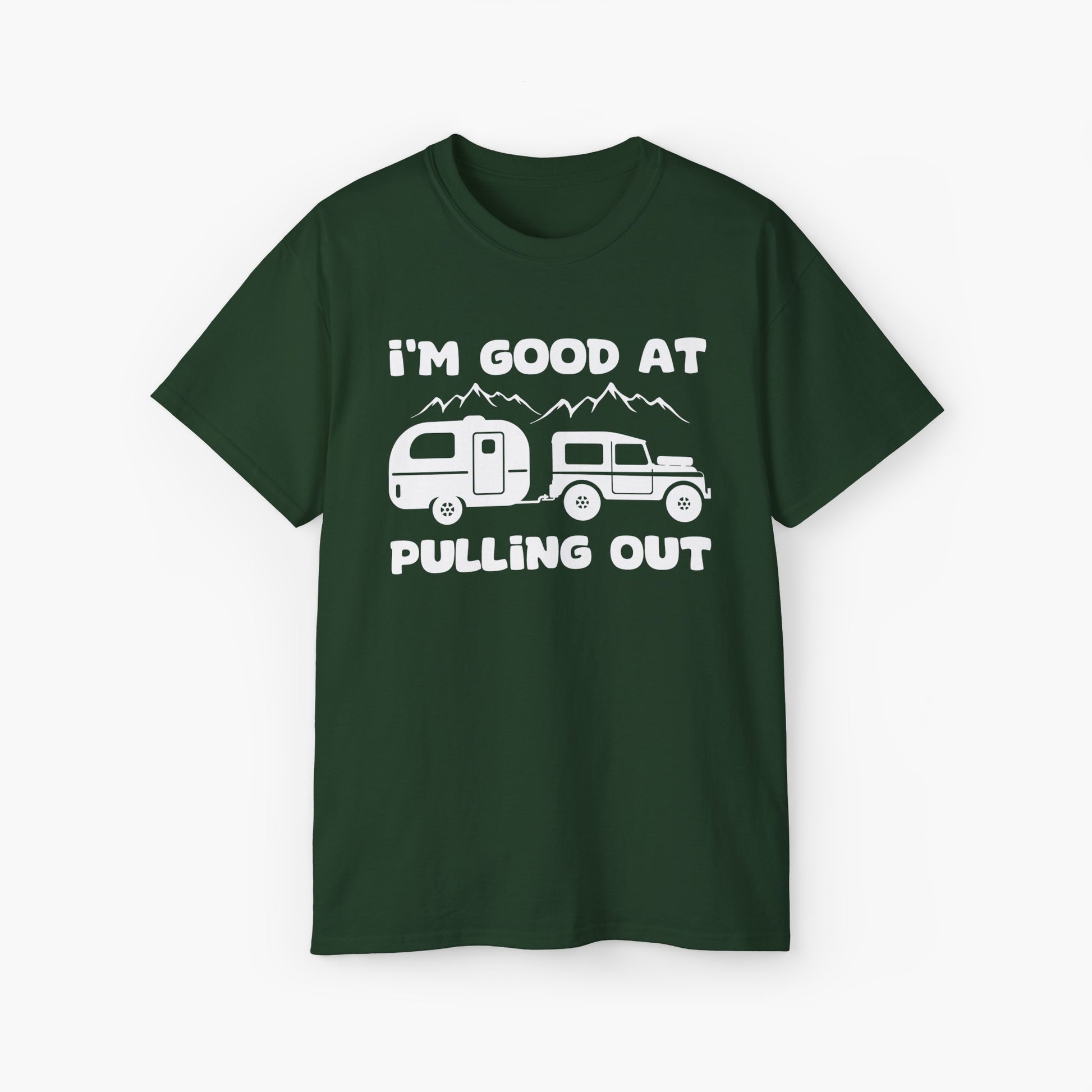 Green t-shirt with humorous text 'I'm good at pulling out' featuring an image of a truck pulling a camping van, set against mountains on a plain background.