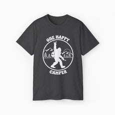 Dark grey t-shirt with 'One Happy Camper' text, featuring Bigfoot making a peace sign, set against a subtle background of trees and mountains.