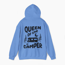 Back of a blue hoodie with the text 'Queen of the Camper' surrounded by elements including a camping van, stars, trees, and a campfire, on a plain background.