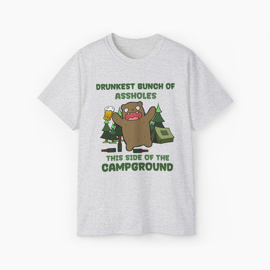 Light grey t-shirt with green text reading 'Drunkest bunch of assholes, this side of the campground,' featuring a drunk bear holding a beer, tent, and trees on a plain background.