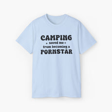 Light blue t-shirt with the bold statement 'Camping saved me from becoming a pornstar,' embellished with stars on a plain background.