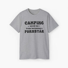 Grey t-shirt with the bold statement 'Camping saved me from becoming a pornstar,' embellished with stars on a plain background.