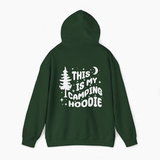Back of green hoodie featuring the text 'This is my camping hoodie,' with a design of a camping van, moon, stars, and a tree on a plain background.