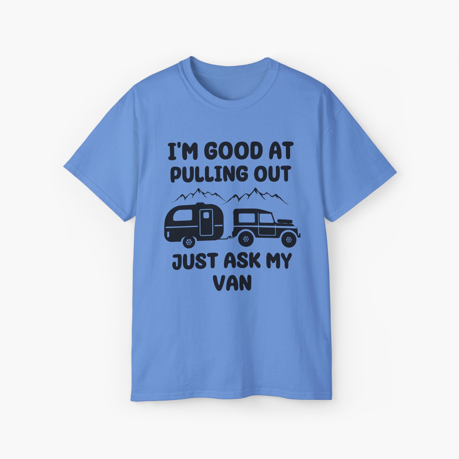 Blue t-shirt with humorous text 'I'm good at pulling out, just ask my van,' featuring an image of a truck pulling a camping van, set against mountains on a plain background.