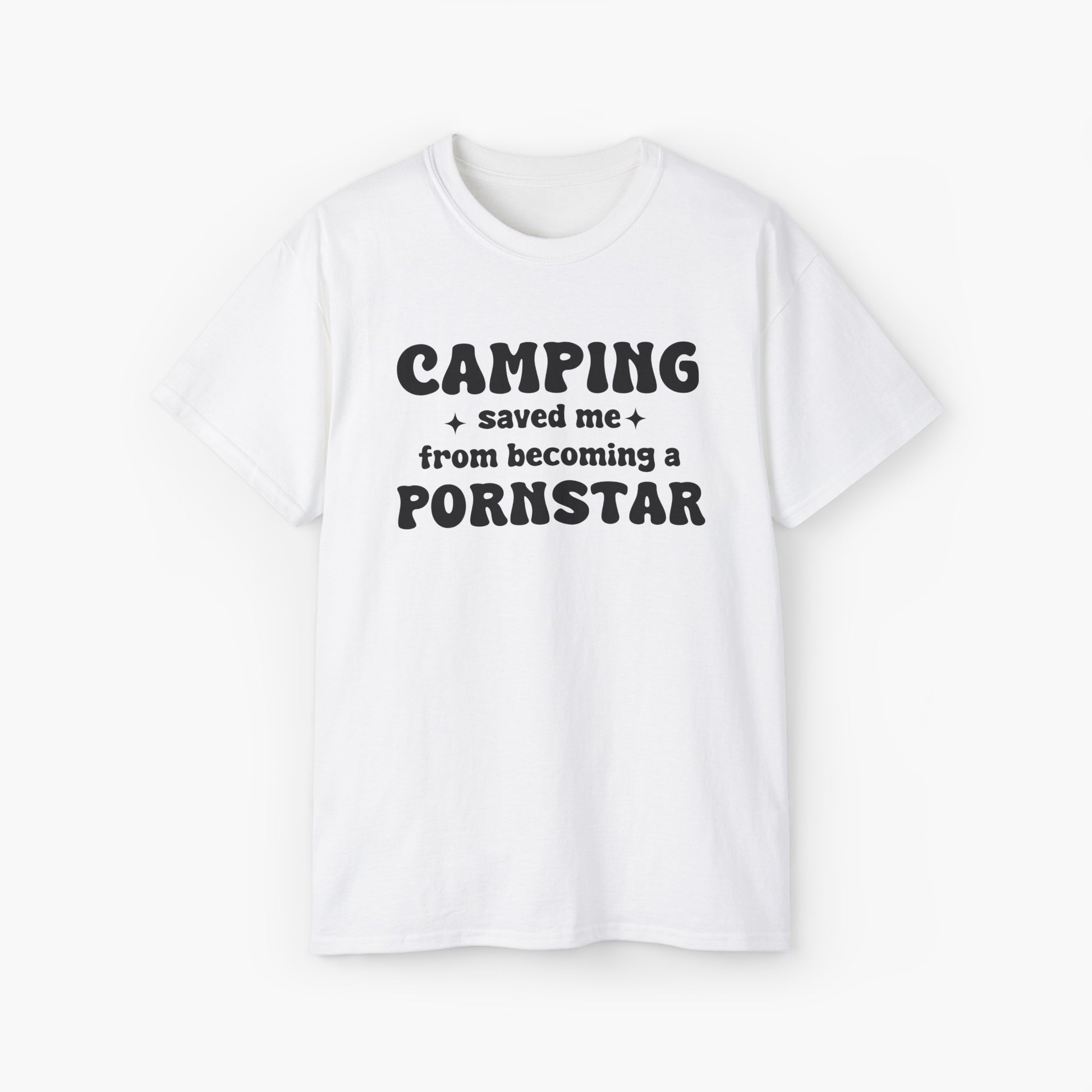 White t-shirt with the bold statement 'Camping saved me from becoming a pornstar,' embellished with stars on a plain background.