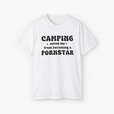 White t-shirt with the bold statement 'Camping saved me from becoming a pornstar,' embellished with stars on a plain background.