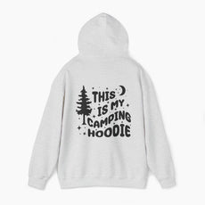 Back of light grey hoodie featuring the text 'This is my camping hoodie,' with a design of a camping van, moon, stars, and a tree on a plain background.