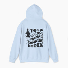 Light blue hoodie with the text 'This is cool mama's camping hoodie' on the back, featuring a tree and stars design on a plain background.