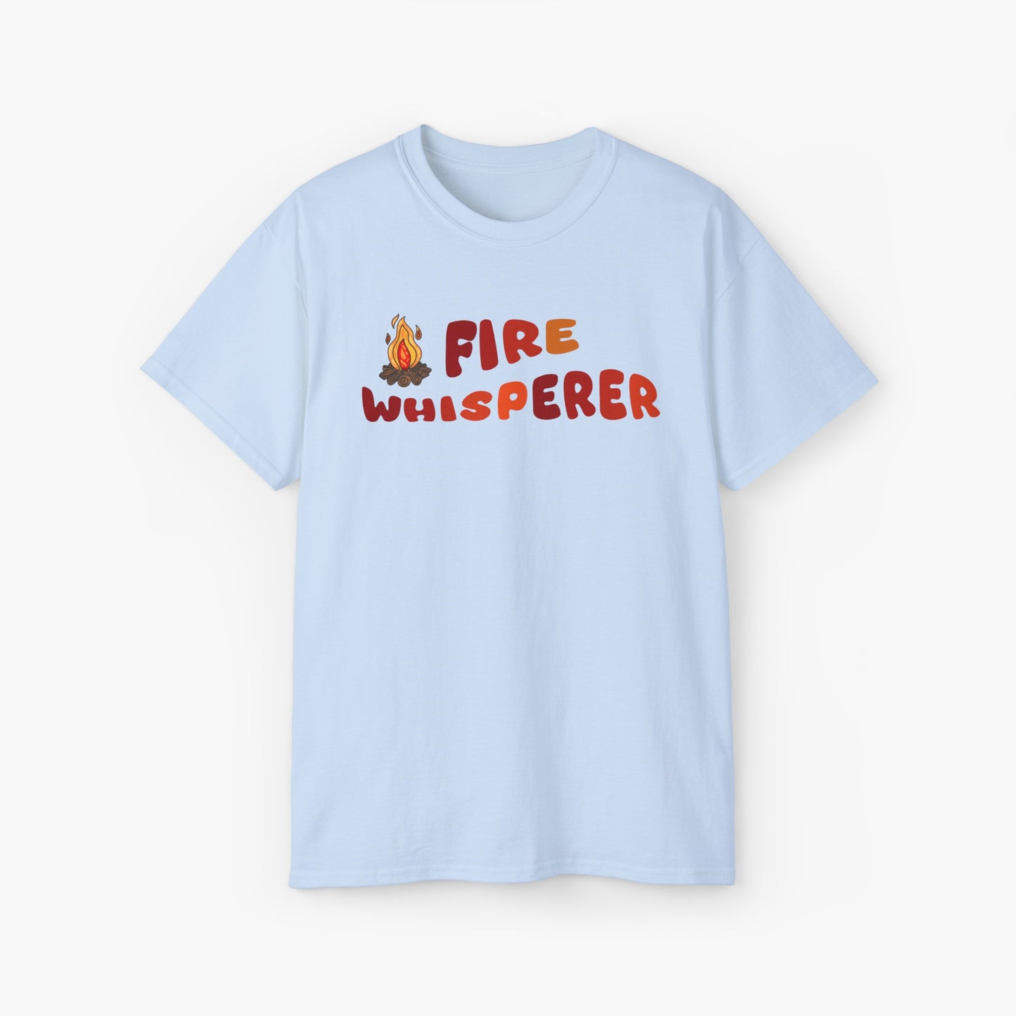 Light blue t-shirt with colorful 'Fire Whisperer' text, featuring a vibrant campfire graphic on a plain background.