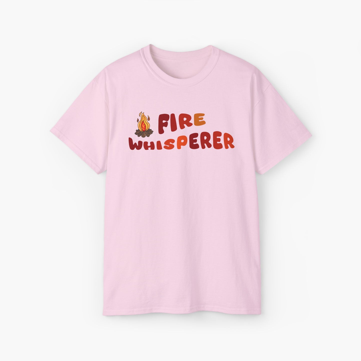 Light pink t-shirt with colorful 'Fire Whisperer' text, featuring a vibrant campfire graphic on a plain background.