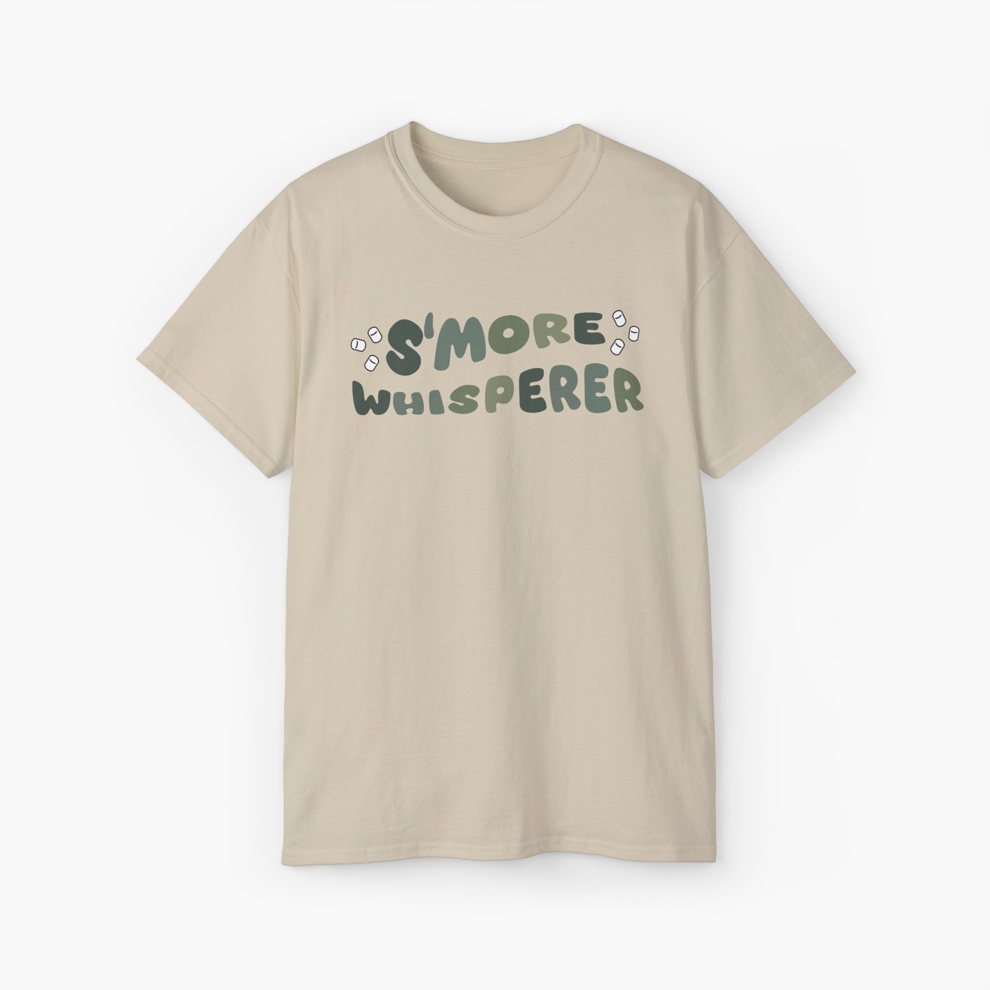 Sand color t-shirt with green text 'S'more Whisperer' and marshmallow graphics on a plain background.