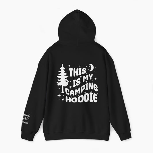 Back of a black hoodie featuring the text 'This is my camping hoodie,' with a design of a camping van, moon, stars, and a tree on a plain background.