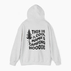 Light grey hoodie with the text 'This is cool mama's camping hoodie' on the back, featuring a tree and stars design on a plain background.